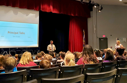 EMS principal speaks to students in the auditorium